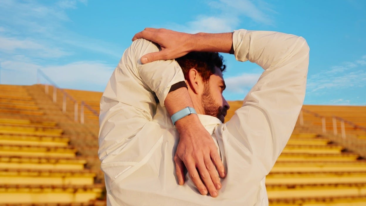 man stretches while wearing google fitbit air on wrist