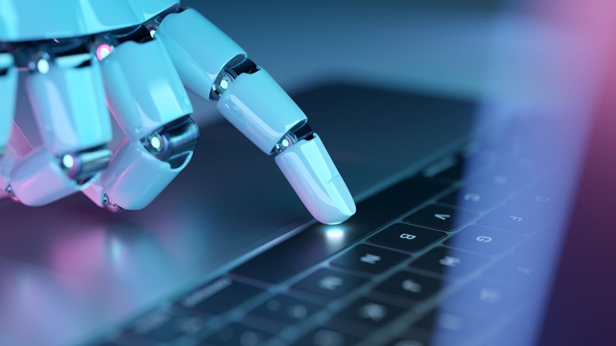 Robot hand typing on keyboard