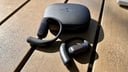black shokz openfit pro case and earbuds on table outside