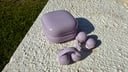 purple sony open earbuds on ledge outside